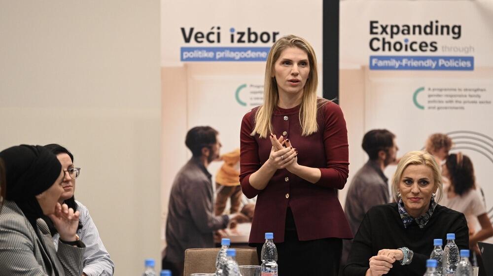 A woman speaking to a group of people sitting